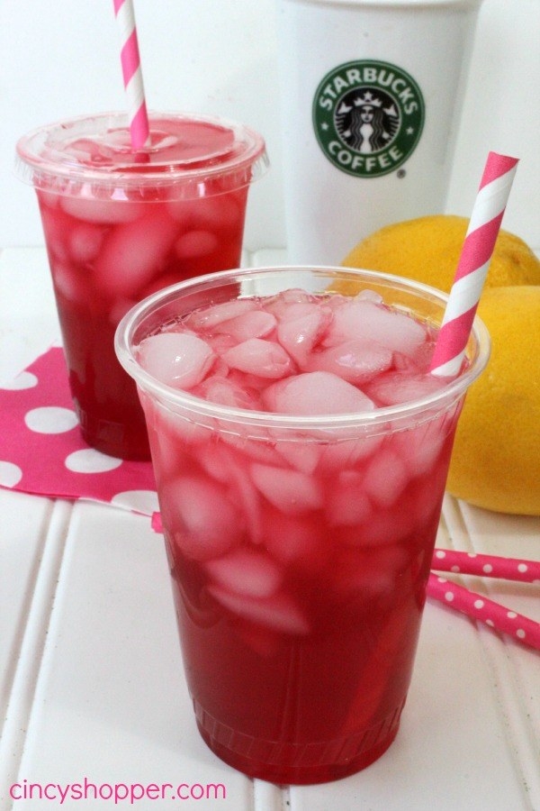 The bright red passion tea lemonade inside a plastic cup with a straw