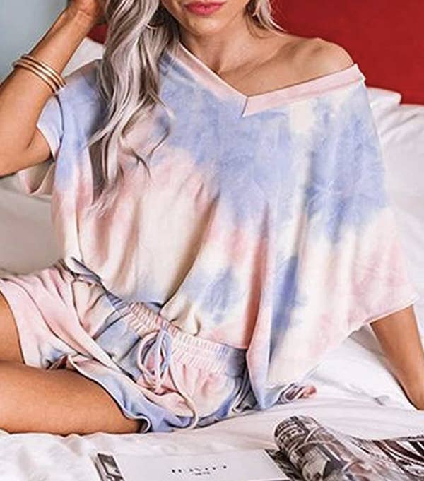 A model in a V-neck oversized tee and elastic drawstring shorts 