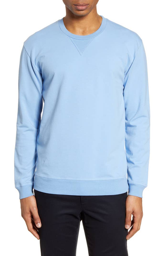Model wearing crewneck sweatshirt in light blue