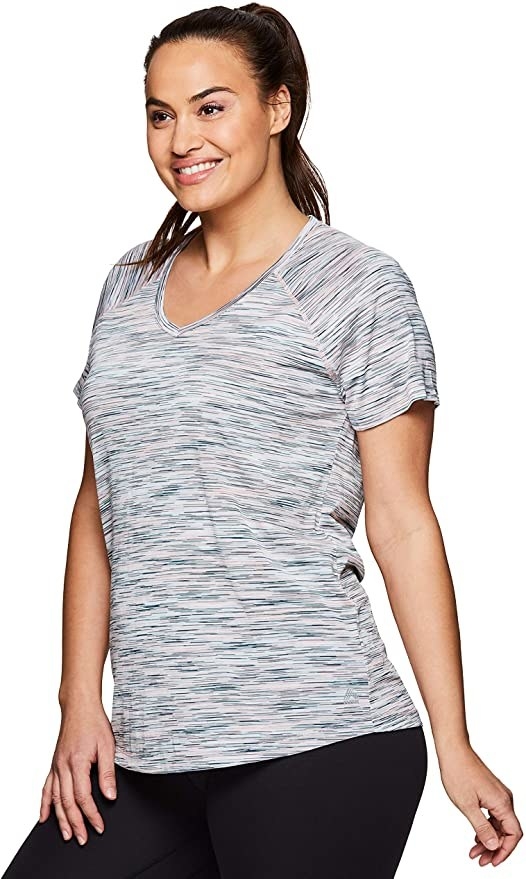 Model wearing tee with striated pattern in green
