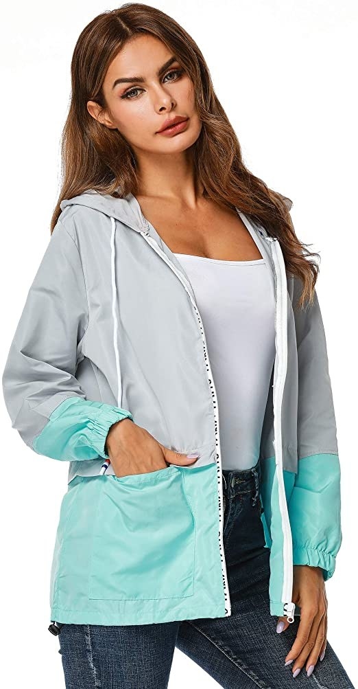 model wearing the blue and gray jacket