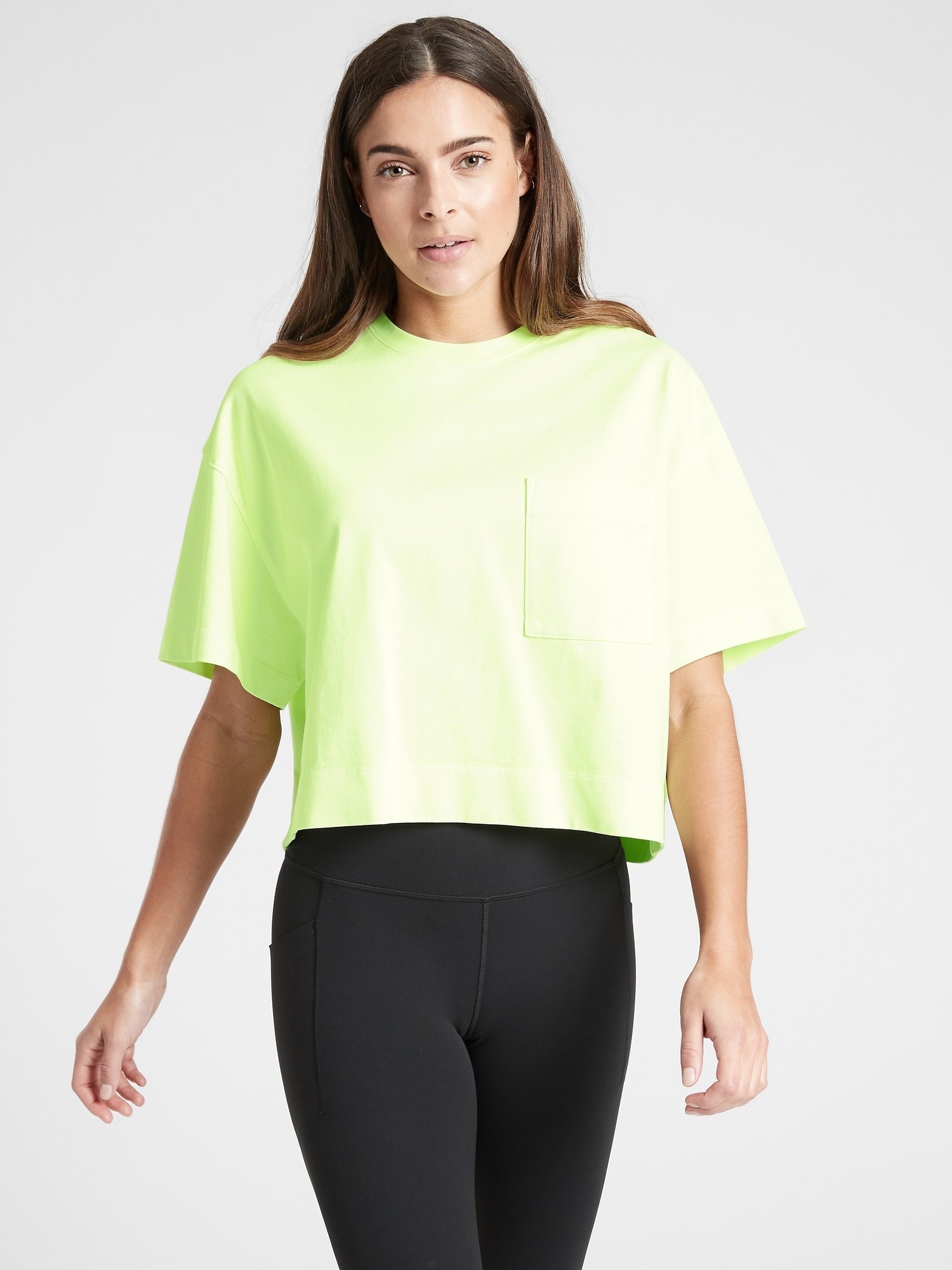 Model wearing cropped lime tee with pocket on left chest
