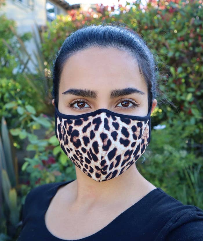 Model wears a leopard print face mask with a black shirt