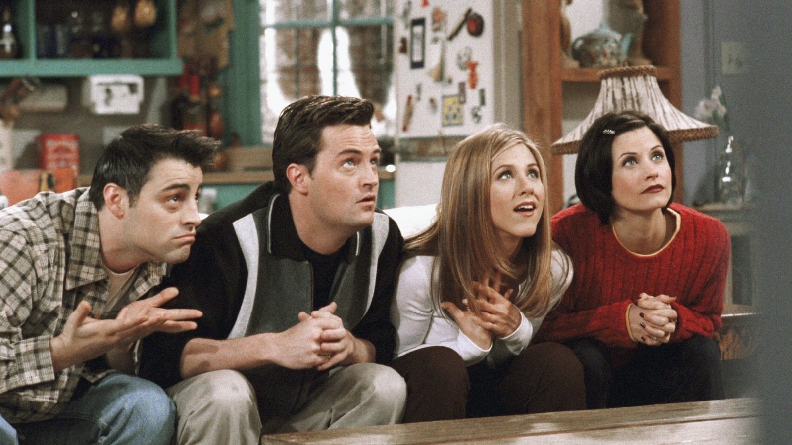Joey, Chandler, Rachel, and Monica looking up expectantly 