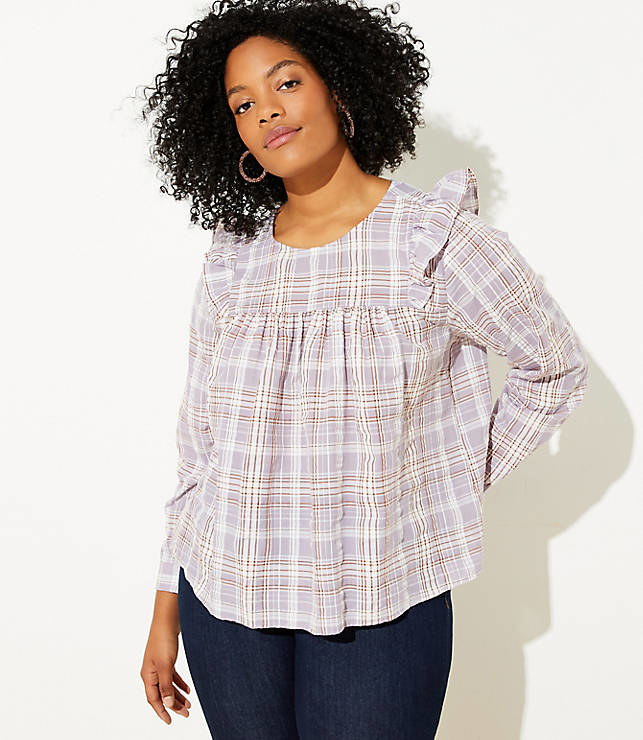 A model wearing the long-sleeve lavender, white, and reddish-brown plaid top