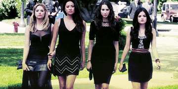 Four characters from Pretty Little Liars in black dresses