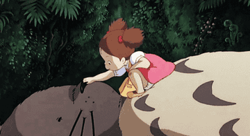 A gif of Mei patting Totoro&#x27;s nose 