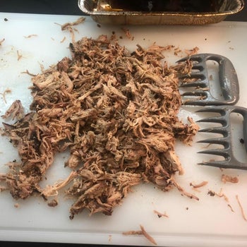 a pile of shredded meat next to the shredder claws