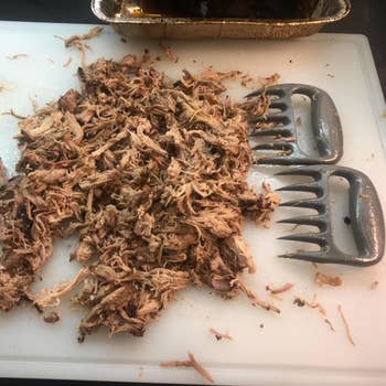 a pile of shredded meat next to the shredder claws