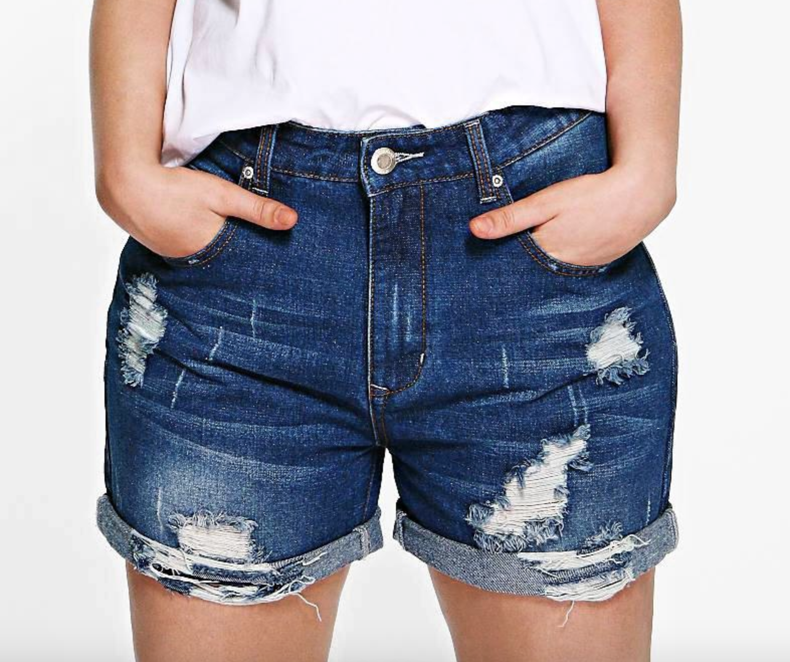 model wearing distressed jean shorts in dark blue 
