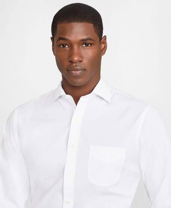 A model wearing a white button up dress shirt