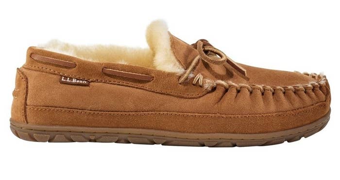 A side view of a tan leather shearling-lined moccasin