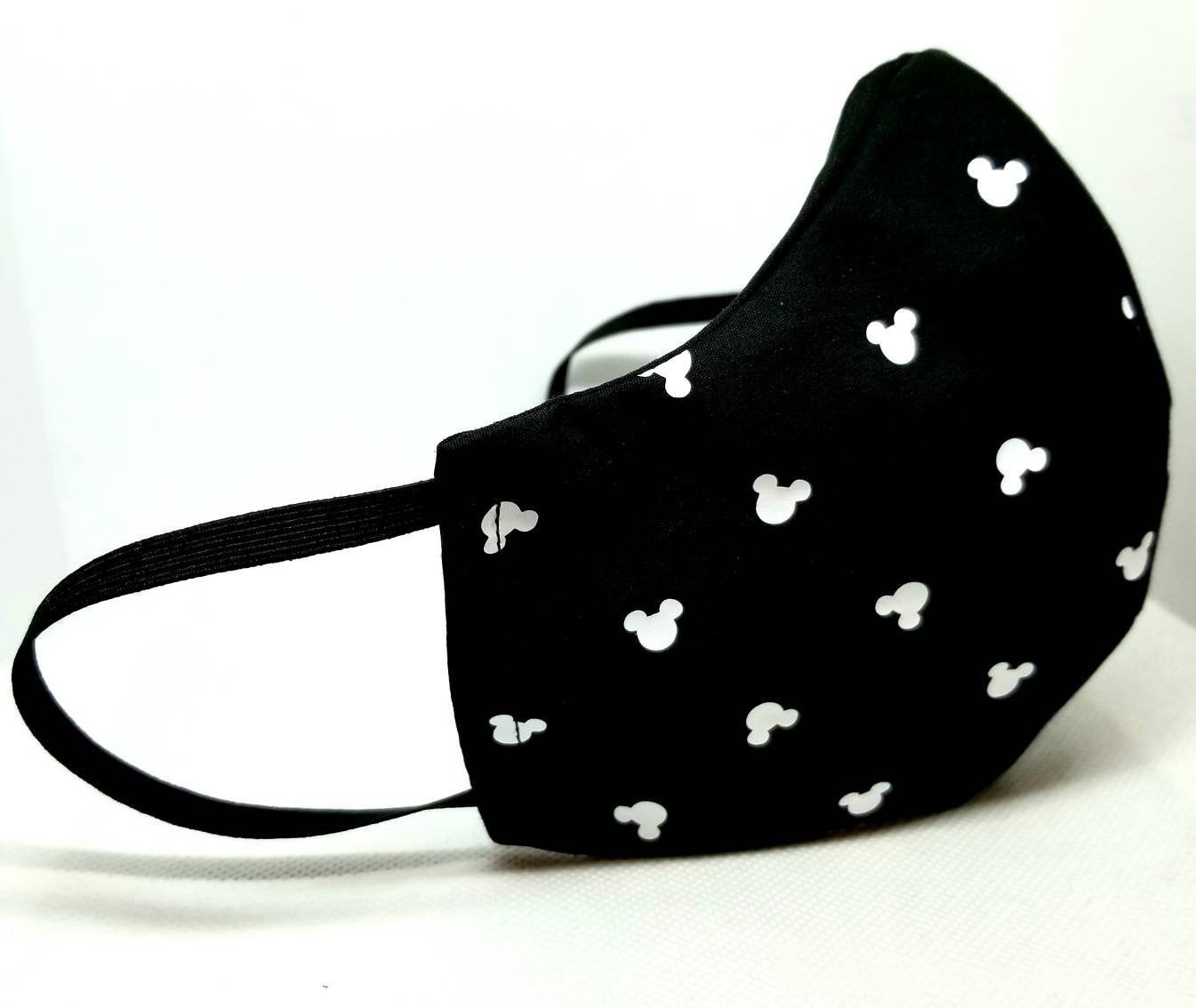 a simple black face mask with white mickey mouse icons on it