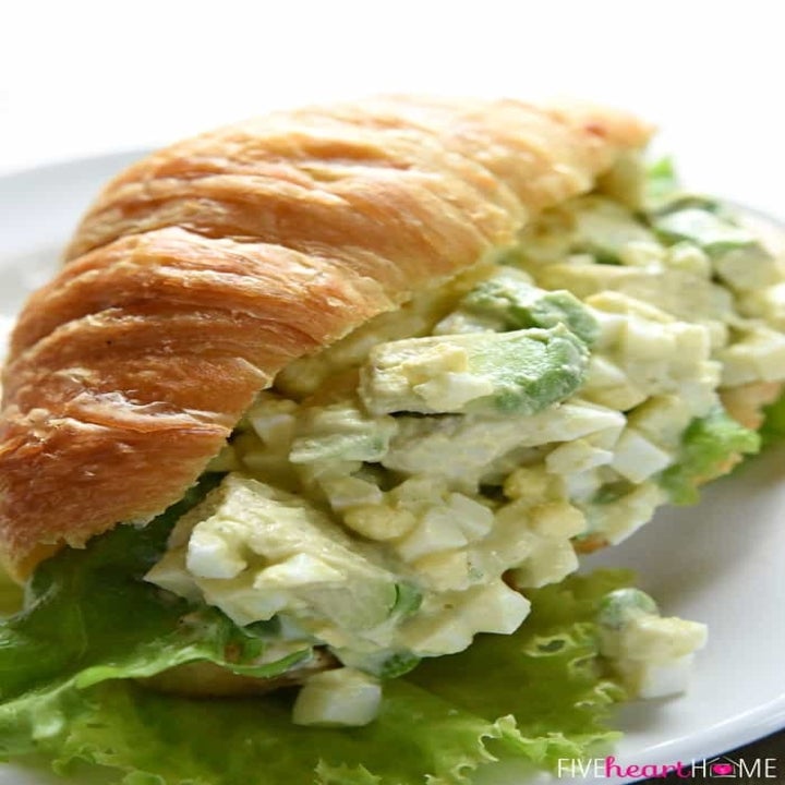 Homemade egg and avocado salad on a croissant.