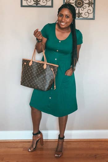 Reviewer wearing the dress in green with heels