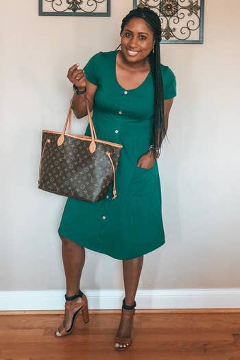 Reviewer wearing the dress in green with heels