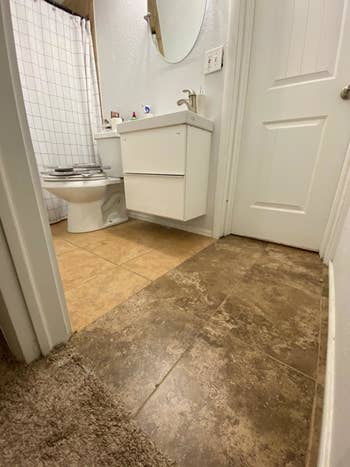 picture of a bathroom with two different colored brown tiles