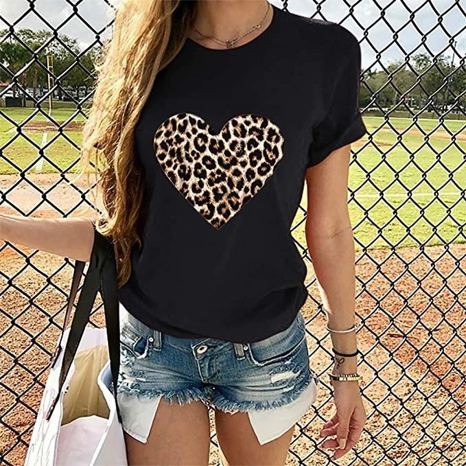 model wearing the black shirt with leopard print heart on it