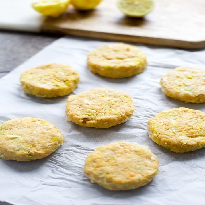 Uncooked chickpea patties on a sheet pan.