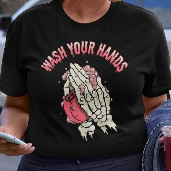 Person wearing the shirt with skeleton hands and soap with &quot;wash your hands&quot; in text
