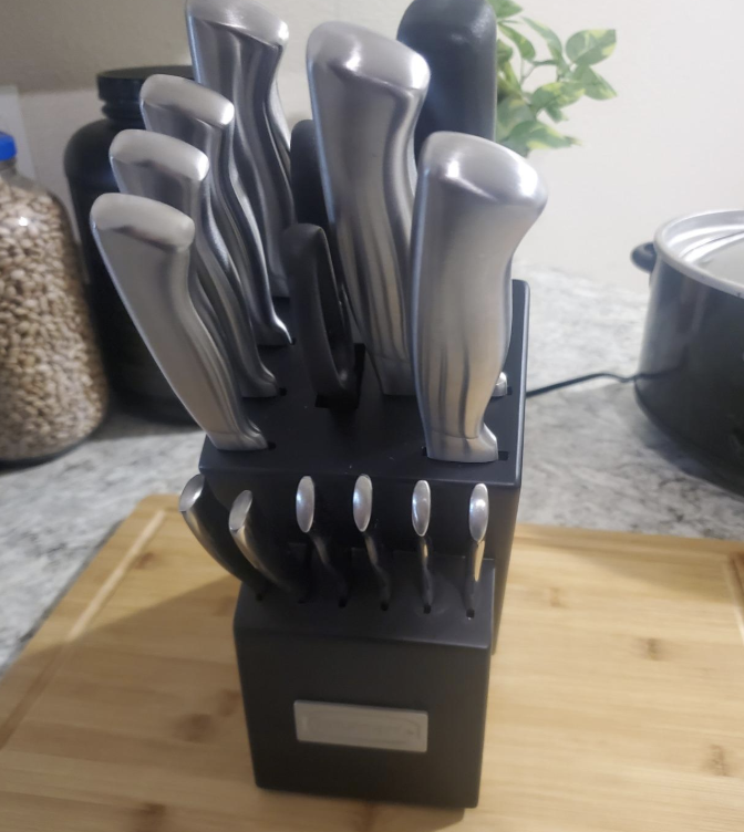 A set of steel knives in a black holder 