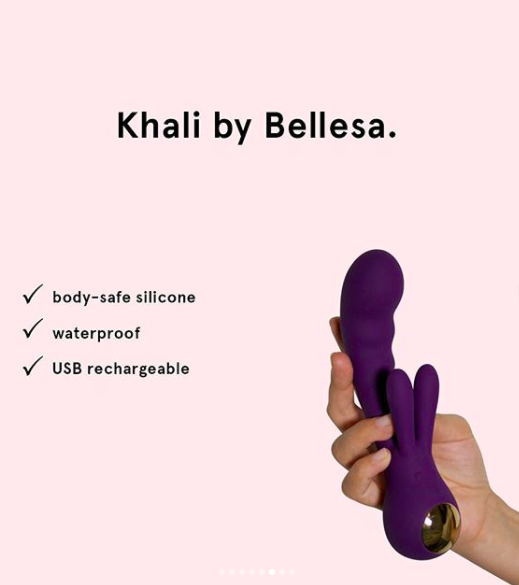 A hand holding the toy in purple next to a list of its features (body-safe silicone, waterproof, USB-rechargeable). The &quot;ears&quot; of the toy are longer and thicker than many rabbit vibrators, and the insertable end is thick and ridged