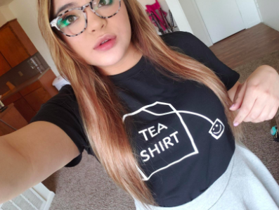 reviewer wearing shirt that has a tea bag illustration with &quot;Tea shirt&quot; written on it