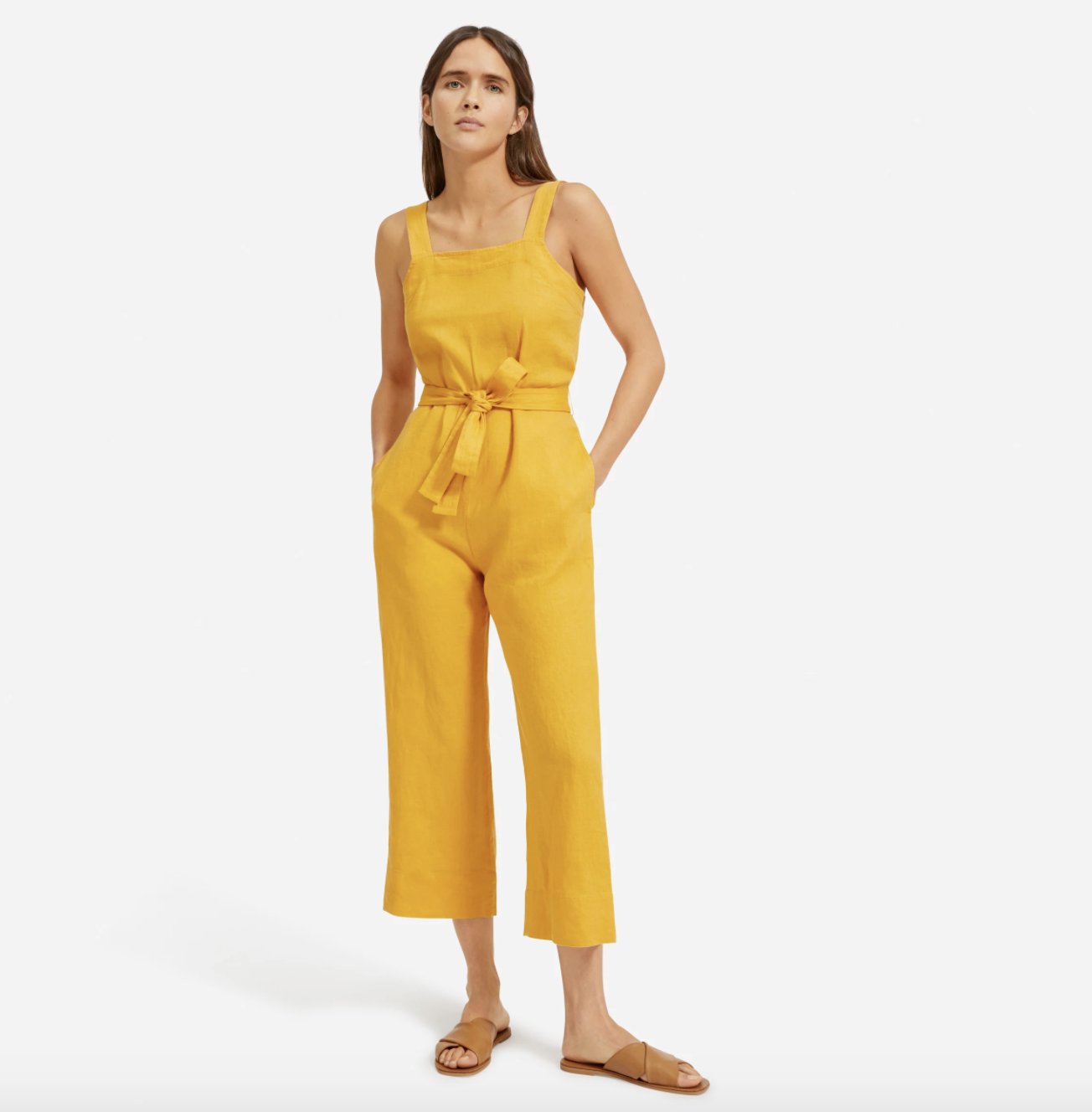 Model wearing the square-neck jumpsuit in gold