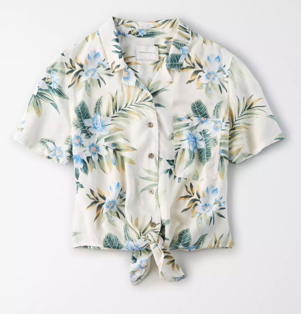 The shirt in white with blue flowers and green leaves