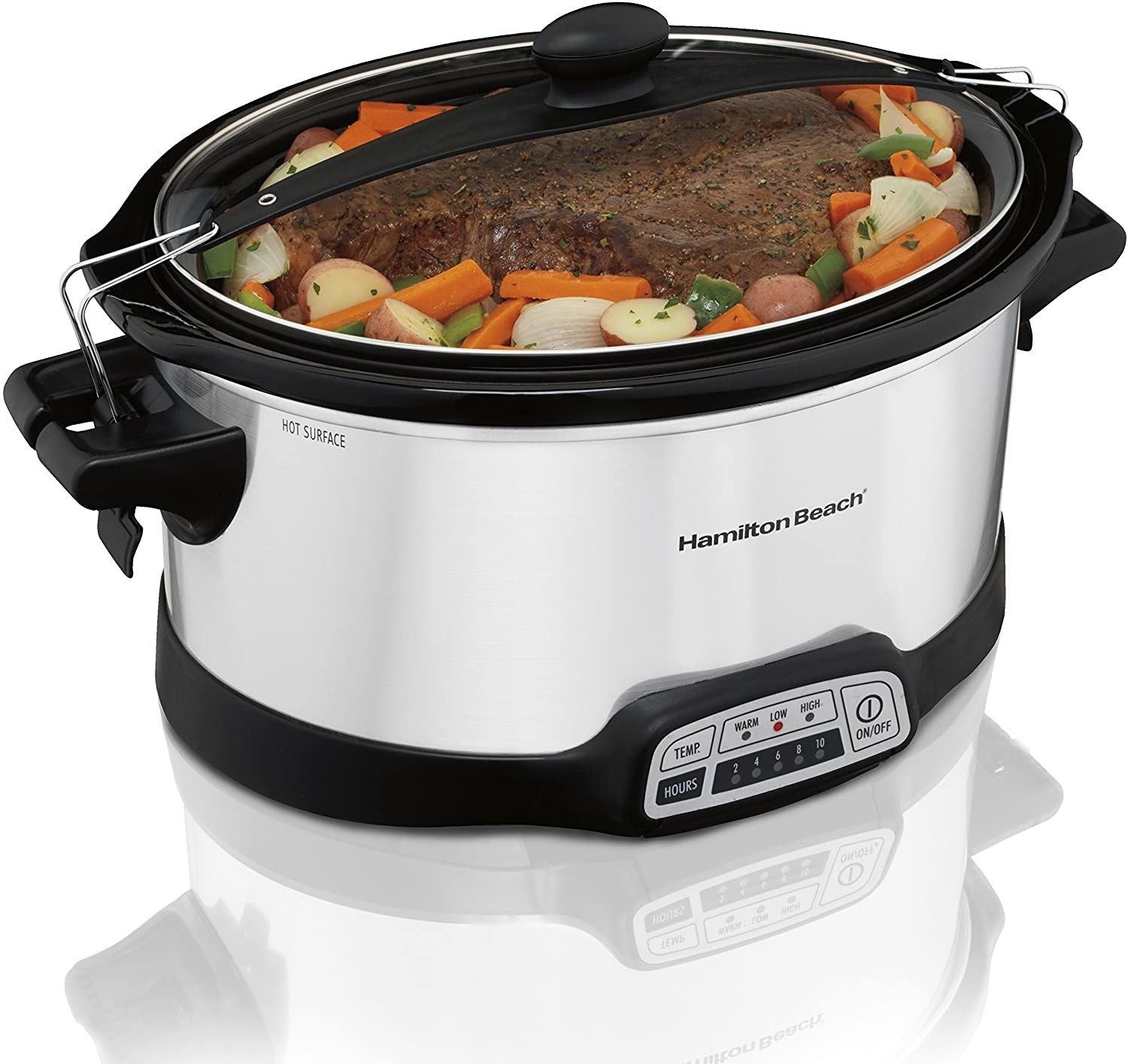 A stainless-steel crock pot with a transparent lid and food cooking inside it 