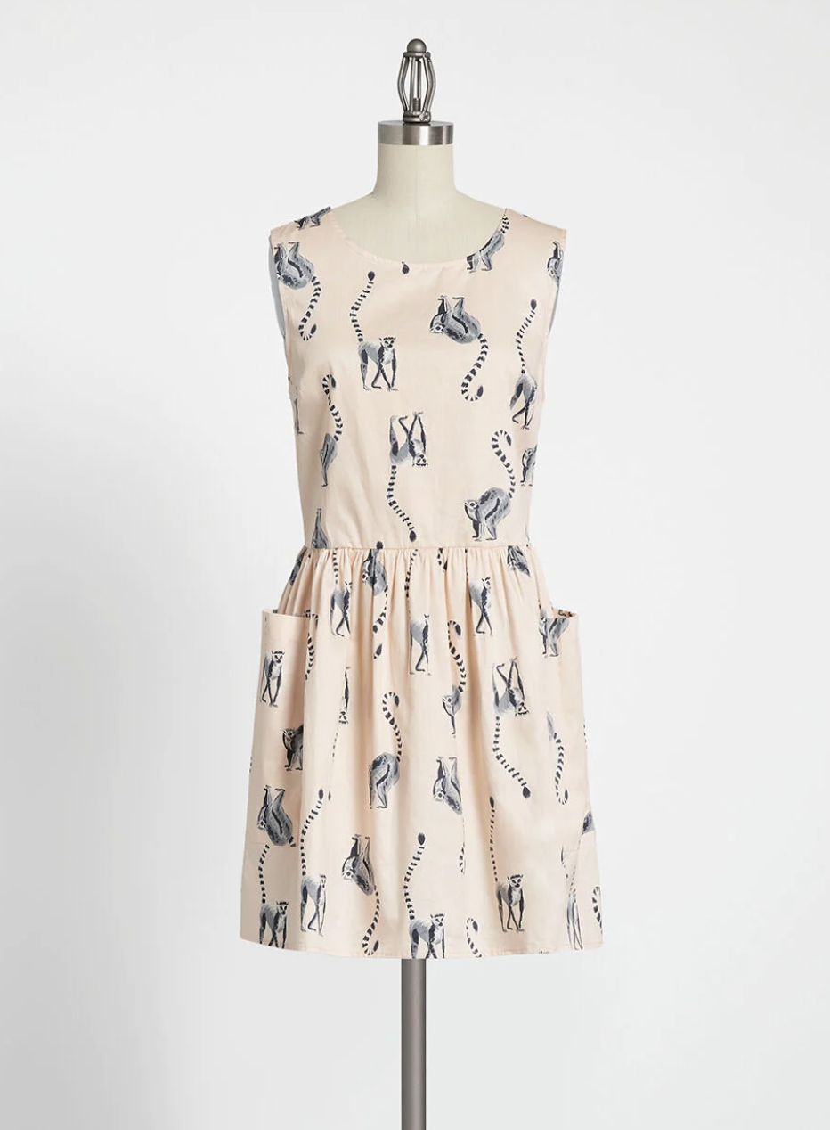 The dress, which is pale pink and has deep front pockets and a scoop neckline