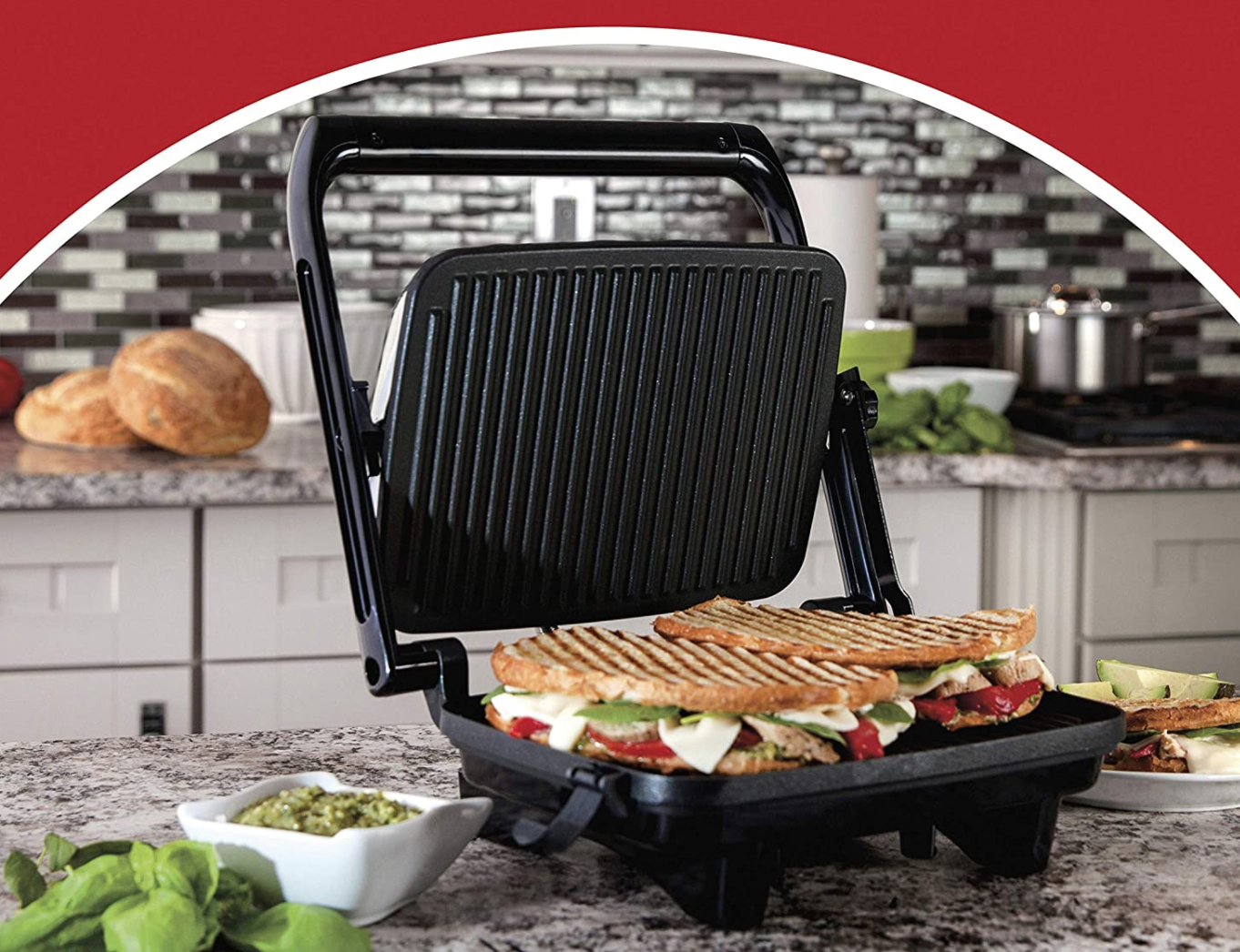 A panini press open with sandwiches cooking on it 