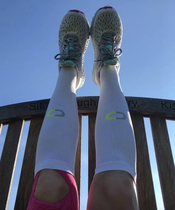 reviewer wearing knee-high white compression socks 
