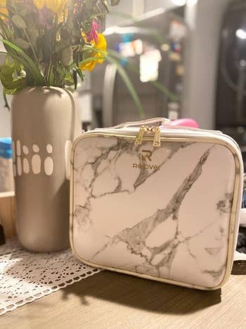 Another reviewer showing  makeup bag's design in marble 