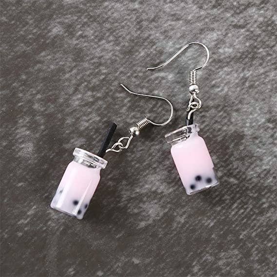 Small earrings that look like a light pink bubble tea with visible bobas