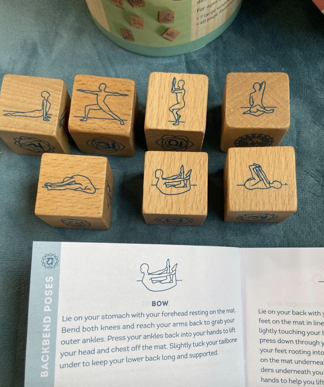 the wooden dice with etchings of various yoga poses 