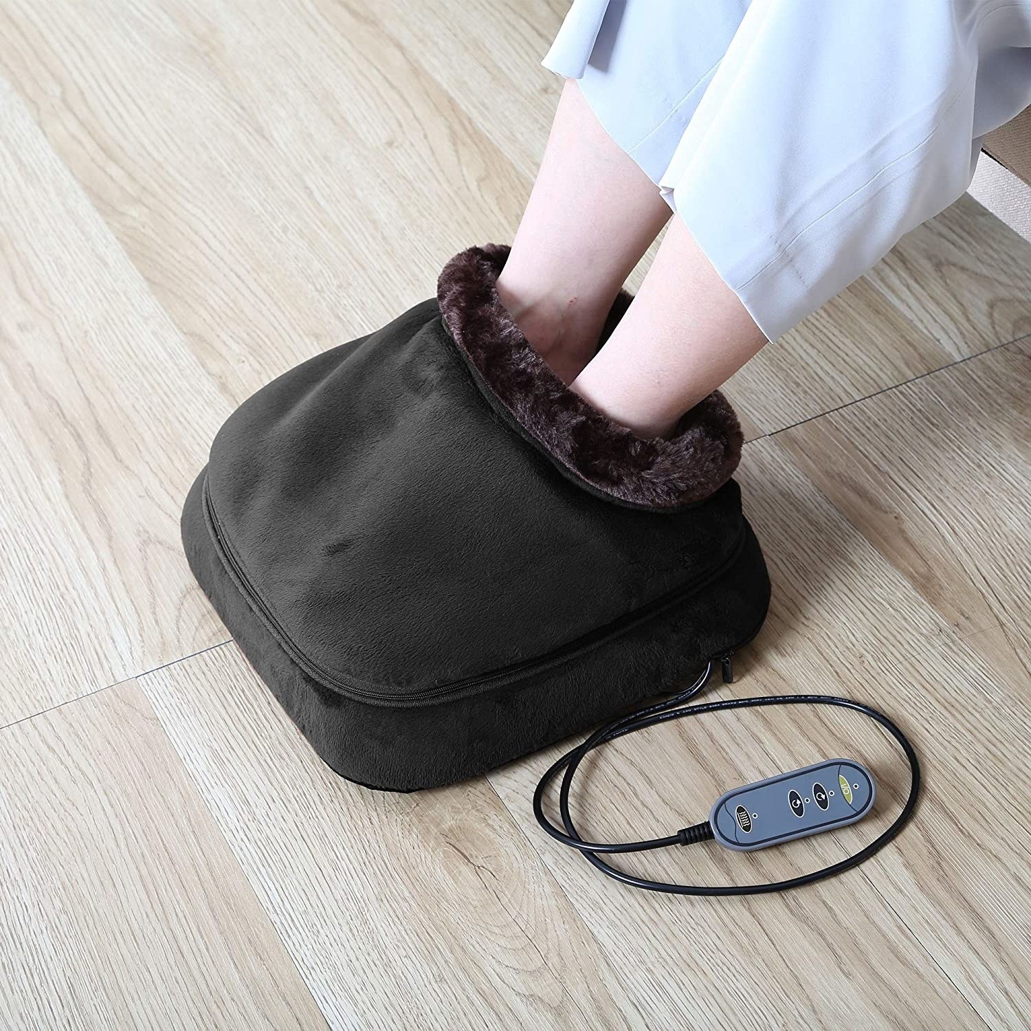 A model with their feet inside the fur-lined massager