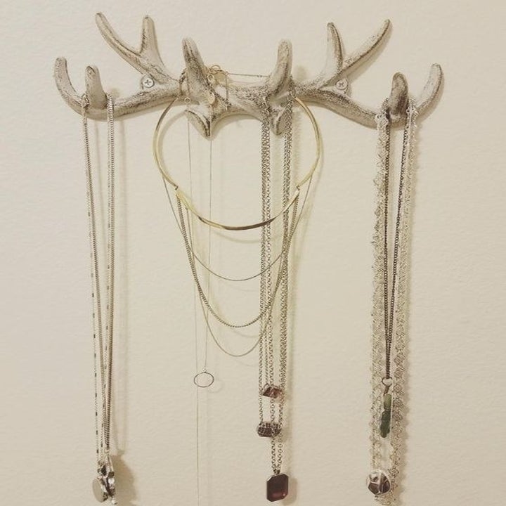 Reviewer using the silver antler hook to organize necklaces 