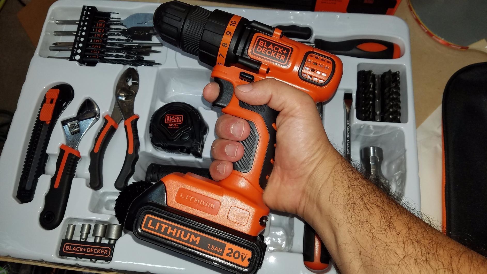 A reviewer showing his tool kit while holding the 