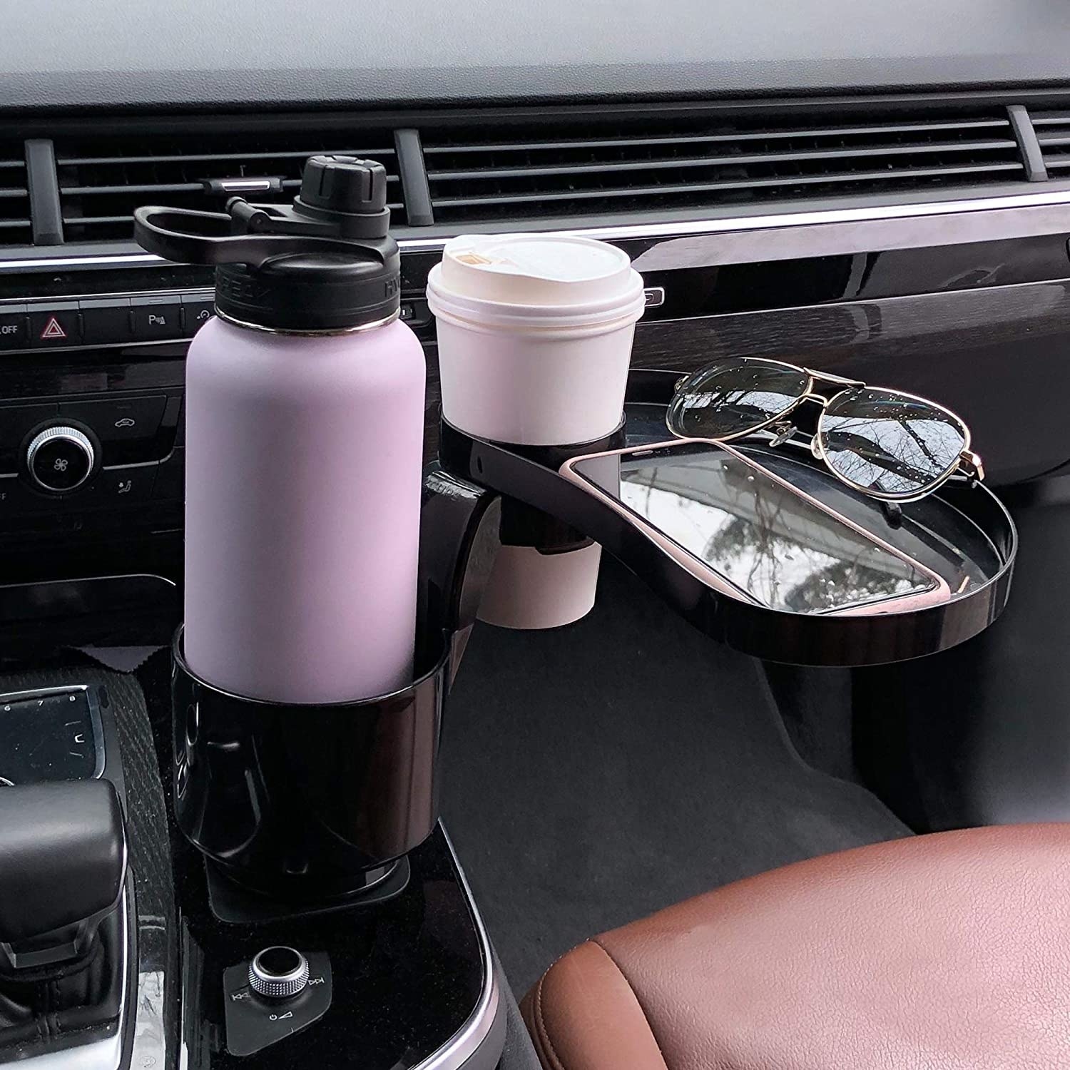 The attachable tray placed in a cup holder inside a car