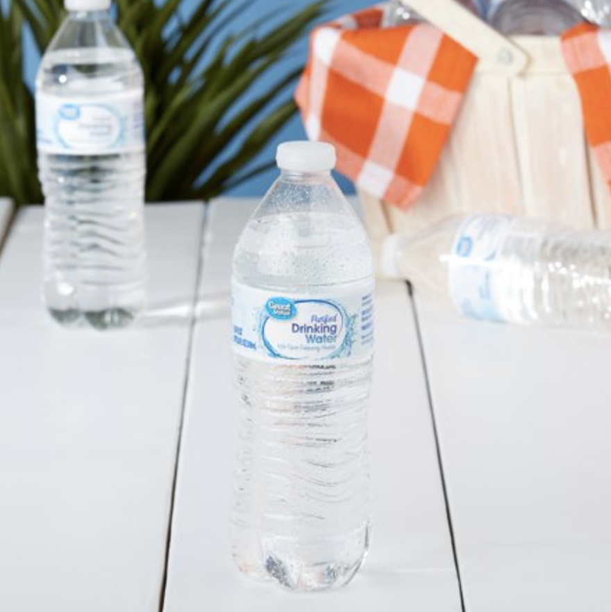 Bottles of Great Value Purified Drinking Water on a picnic table