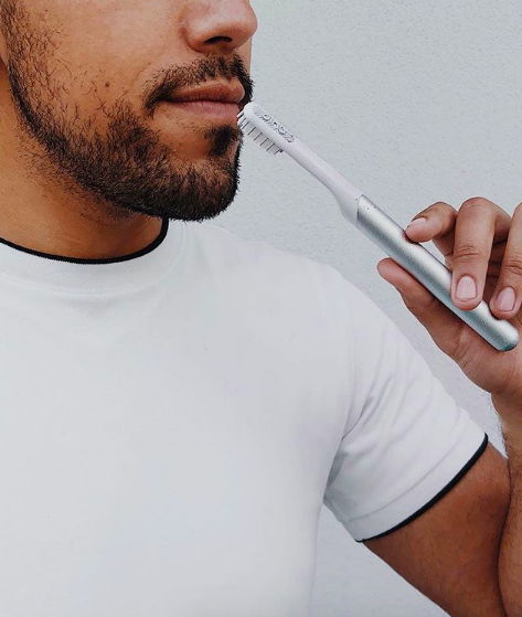 A model holding the toothbrush