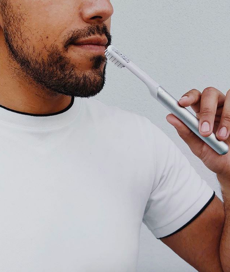 A model holding the toothbrush 