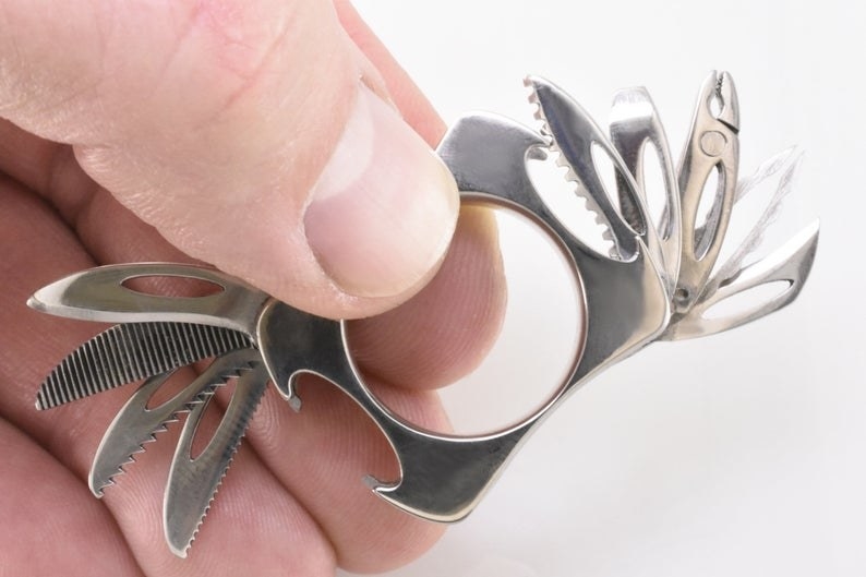 A closeup of the ring, with nine different mini tools extending from either side 