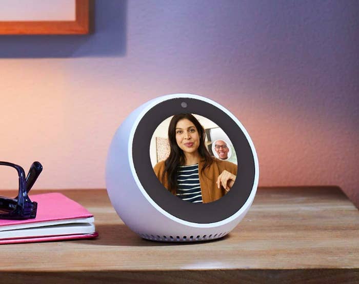 A lifestyle shot of the Echo Spot with a video chat displayed on the screen