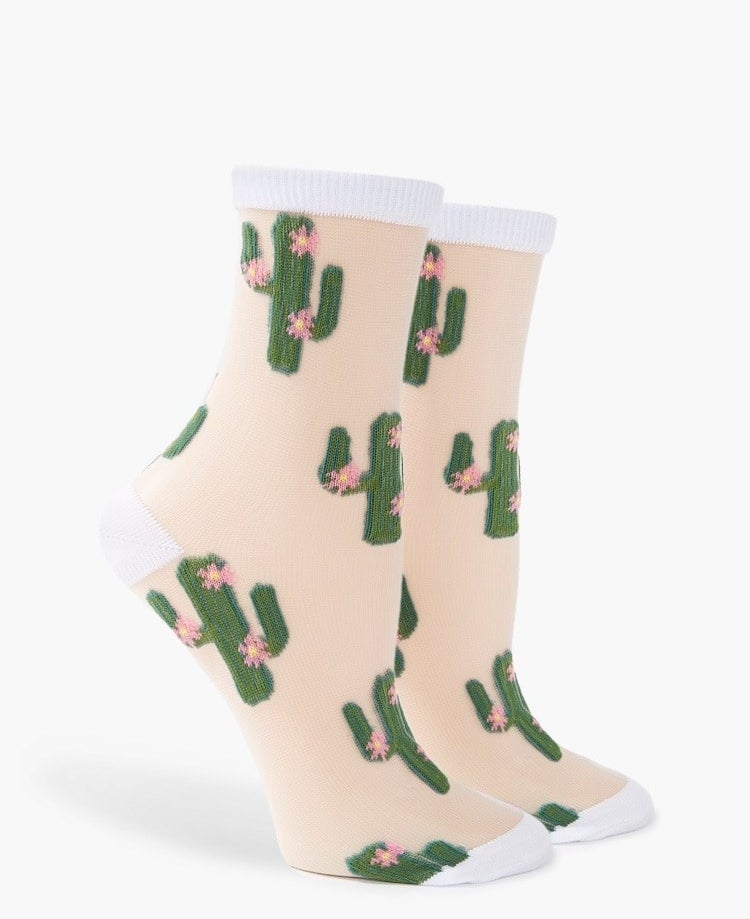 The socks with white around the toe, heel, and top and green cacti with pink flowers all over the rest