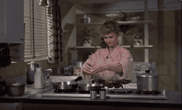 debbie reynolds in the movie &quot;susan slept here&quot; cracking an egg and throwing the shell over her shoulder