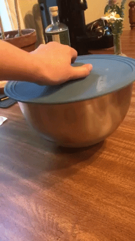 gif of writer's hand picking up a bowl by the lid's handle, then flipping it open to reveal cookie dough