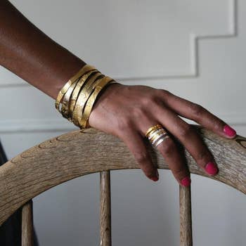 The stackable bangles and rings rings on a hand