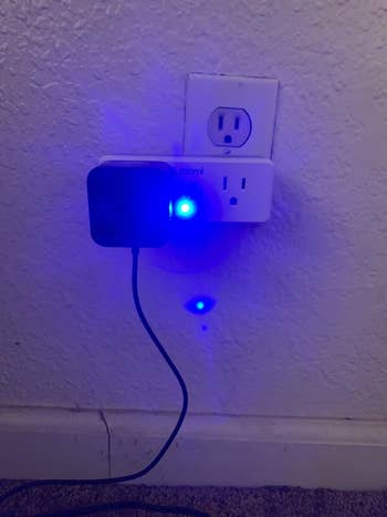 A reviewer image of something plugged into an outlet emitting an intensely bright blue light